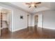Serene main bedroom with hardwood floors, a trey ceiling, and multiple doorways creating a seamless flow throughout the living space at 996 Tender Dr, Apex, NC 27502