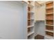 Well-organized walk-in closet featuring custom shelving and wooden accents for ample storage and a touch of style at 996 Tender Dr, Apex, NC 27502