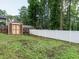 Fenced backyard with shed and healthy grass at 100 Upton Ct, Garner, NC 27529