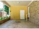 Covered carport area with brick siding and access to an exterior door at 100 Upton Ct, Garner, NC 27529