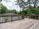 Spacious wooden deck offering an outdoor living space with views of the surrounding greenery at 100 Upton Ct, Garner, NC 27529