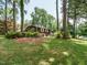 Charming home exterior nestled among mature trees and landscaping at 100 Upton Ct, Garner, NC 27529