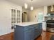 Eat-in kitchen with island featuring white countertop and blue cabinets at 100 Upton Ct, Garner, NC 27529