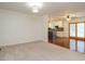 Spacious living area with hardwood and carpet flooring, opening to a modern kitchen at 100 Upton Ct, Garner, NC 27529