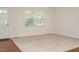 Sunlit living room with carpet, windows and neutral walls, offering a clean and inviting space at 100 Upton Ct, Garner, NC 27529
