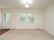 Bright living room featuring carpet, two windows and a glass paneled door at 100 Upton Ct, Garner, NC 27529
