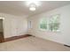Bright living room with hardwood floors and carpet and a glass paneled door at 100 Upton Ct, Garner, NC 27529
