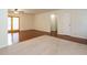 Open-concept living room with hardwood floors and access to the backyard through sliding glass doors at 100 Upton Ct, Garner, NC 27529