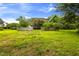 Spacious backyard with lawn, wooden fence, and foliage at 1016 Pasture View Ln, Raleigh, NC 27603