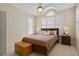 Cozy bedroom with a trey ceiling, wooden furnishings, large windows with plantation shutters, and neutral carpet at 1016 Pasture View Ln, Raleigh, NC 27603