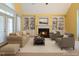 Comfortable living room featuring a fireplace, built-in shelves, and cozy seating at 1016 Pasture View Ln, Raleigh, NC 27603