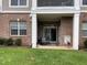 Covered patio with outdoor seating, brick facade, and green grass at 10411 Rosegate Court # 6, Raleigh, NC 27617