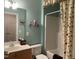 Bright bathroom with vanity, bathtub and shower with floral curtain at 10411 Rosegate Court # 6, Raleigh, NC 27617