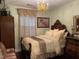 Bedroom with olive walls, wooden furniture, bed and neutral decor at 10411 Rosegate Court # 6, Raleigh, NC 27617