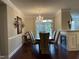 Formal dining room with elegant chandelier, fireplace, and outdoor access at 10411 Rosegate Court # 6, Raleigh, NC 27617