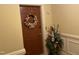 Apartment door with a tulip wreath and a flower arrangement, creating a warm welcome at 10411 Rosegate Court # 6, Raleigh, NC 27617
