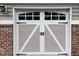 Garage door with decorative windows, white trim, and taupe panels at 10411 Rosegate Court # 6, Raleigh, NC 27617