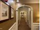Hallway featuring decorative arches, neutral paint, framed artwork, and patterned carpet at 10411 Rosegate Court # 6, Raleigh, NC 27617