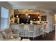 View of kitchen island with bar stool seating and modern pendant lighting at 10411 Rosegate Court # 6, Raleigh, NC 27617