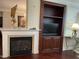 Comfortable living area with a fireplace, built-in shelving, and hardwood floors at 10411 Rosegate Court # 6, Raleigh, NC 27617