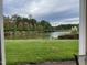 Scenic view of a tranquil pond surrounded by lush greenery and trees with changing autumn leaves, enhancing the natural beauty at 10411 Rosegate Court # 6, Raleigh, NC 27617