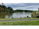 Picturesque view of a pond with fountains, complemented by green lawns and trees, offering a serene outdoor experience at 10411 Rosegate Court # 6, Raleigh, NC 27617