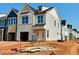 New construction home with white siding, large windows, and a front-entry two-car garage at 107 Ripple Way # 209, Clayton, NC 27520