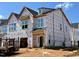 New construction home with protective wrap, featuring modern architectural details and ample window space at 107 Ripple Way # 209, Clayton, NC 27520