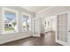 Sunlit office space featuring hardwood floors, large windows, and glass french doors at 1124 Dartford Green Pl, Wake Forest, NC 27587