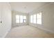 Bright bedroom featuring large windows and crown molding details at 1221 Dixie Trl, Raleigh, NC 27607