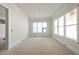 Bright bedroom featuring large windows and crown molding details at 1221 Dixie Trl, Raleigh, NC 27607