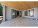 Covered patio with stone flooring and a wood planked ceiling, ready for outdoor living at 1221 Dixie Trl, Raleigh, NC 27607
