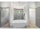 An elegant bathroom features a soaking tub with a window and a separate tiled shower at 1225 Dixie Trl, Raleigh, NC 27607