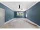 A bright bedroom with large windows and ceiling fan is ready for custom design touches at 1225 Dixie Trl, Raleigh, NC 27607