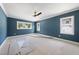 An inviting bedroom with natural light and three windows offers a relaxing retreat at 1225 Dixie Trl, Raleigh, NC 27607
