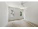 A bright bedroom with large windows and a white ceiling fan, awaits personalization at 1225 Dixie Trl, Raleigh, NC 27607