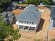 New two-story home with a gray roof, white siding, and a welcoming front porch with stone accents at 1225 Dixie Trl, Raleigh, NC 27607