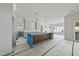 Open kitchen design featuring a central island with pendant lighting and white cabinetry at 1225 Dixie Trl, Raleigh, NC 27607