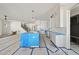 Open-concept kitchen flowing into a living space, featuring a center island and white cabinetry at 1225 Dixie Trl, Raleigh, NC 27607