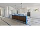 Kitchen showcasing a central island, white cabinets, and modern pendant lighting fixtures at 1225 Dixie Trl, Raleigh, NC 27607