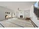 Living room featuring sliding glass doors, fireplace, white walls, and a modern ceiling fan at 1225 Dixie Trl, Raleigh, NC 27607
