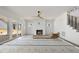 Bright living room features a modern ceiling fan, fireplace and sliding glass doors at 1225 Dixie Trl, Raleigh, NC 27607