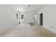 A bright main bedroom with a ceiling fan and view to the ensuite bathroom at 1225 Dixie Trl, Raleigh, NC 27607