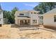 View of the home's rear exterior featuring a covered patio and manicured lawn at 1225 Dixie Trl, Raleigh, NC 27607