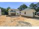 Backyard view showcasing the home's rear exterior, detached garage, and ample yard space at 1225 Dixie Trl, Raleigh, NC 27607