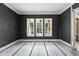 Room with dark gray walls, white trim, three windows, and a doorway visible on the right at 1225 Dixie Trl, Raleigh, NC 27607