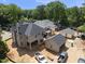 An aerial view of a two-story home featuring a chimney, garage, and covered patio at 1229 Dixie Trl, Raleigh, NC 27607