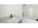 Bathroom featuring a gray vanity, shower with elegant white tiling and black fixtures at 1229 Dixie Trl, Raleigh, NC 27607