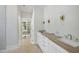 Bright bathroom featuring double vanity, white cabinets and trim, and modern fixtures at 1229 Dixie Trl, Raleigh, NC 27607