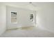 Bright bedroom with large windows, white trim, ceiling fan, and neutral walls create a serene atmosphere at 1229 Dixie Trl, Raleigh, NC 27607